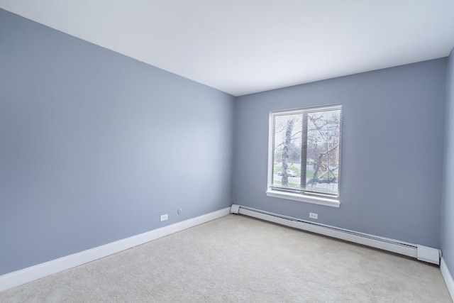 carpeted spare room featuring a baseboard radiator