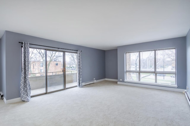 spare room with carpet, a healthy amount of sunlight, and a baseboard radiator