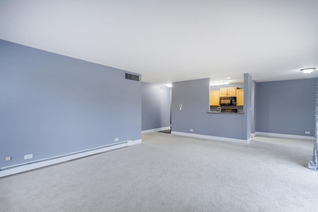 unfurnished living room with light colored carpet and baseboard heating