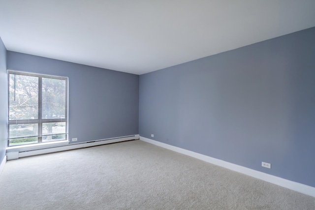 empty room with baseboard heating and carpet flooring