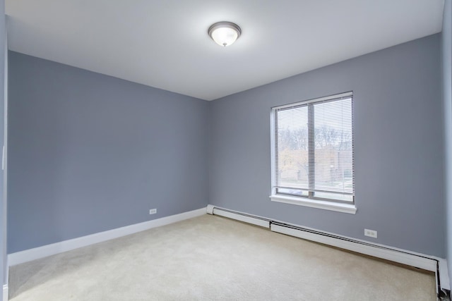 carpeted empty room featuring baseboard heating