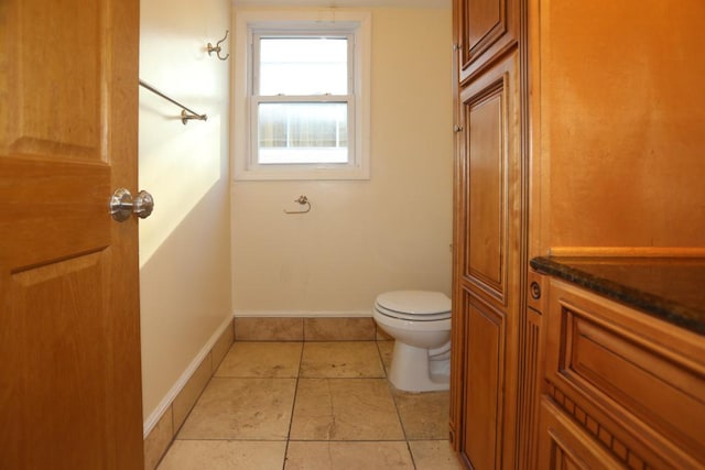 bathroom featuring tile patterned flooring and toilet