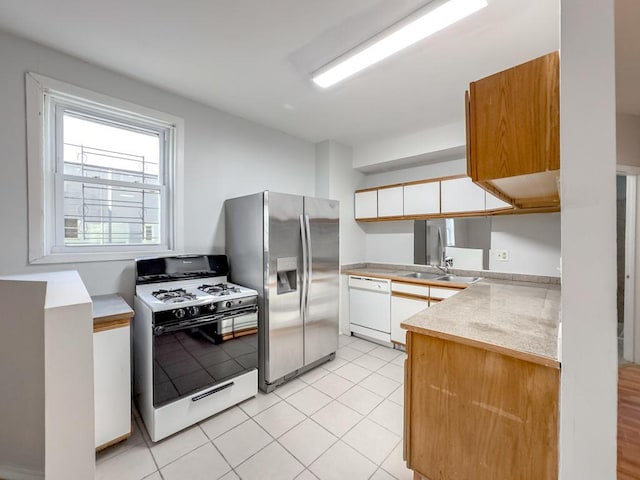 kitchen featuring white cabinetry, light tile patterned flooring, white appliances, and sink