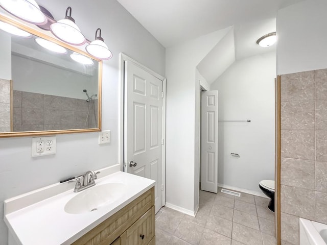 bathroom featuring tile patterned flooring, vanity, and toilet