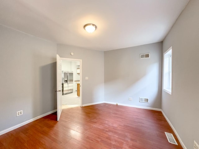 empty room featuring wood-type flooring