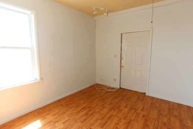 empty room with hardwood / wood-style flooring