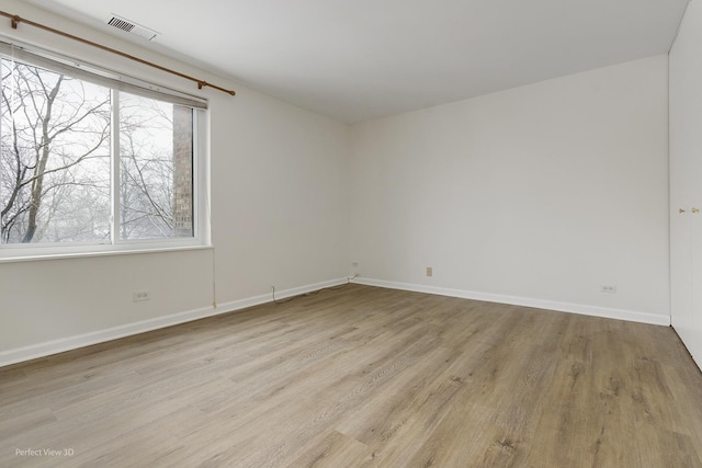 spare room with light hardwood / wood-style floors