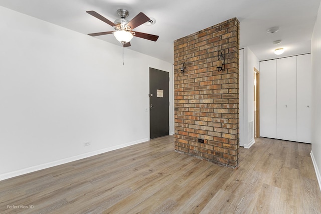 empty room featuring ceiling fan and light wood-type flooring