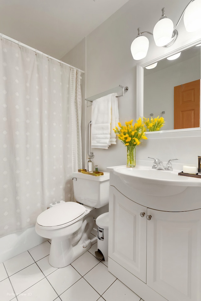 bathroom featuring toilet, tile patterned flooring, and vanity