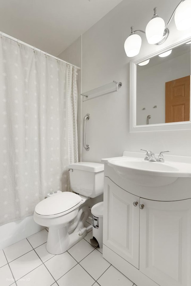 bathroom featuring toilet, tile patterned flooring, and vanity