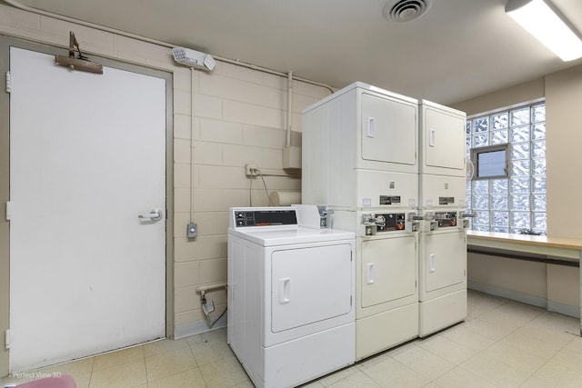 clothes washing area featuring washing machine and dryer and stacked washer / drying machine