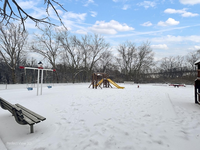 snowy yard with a playground