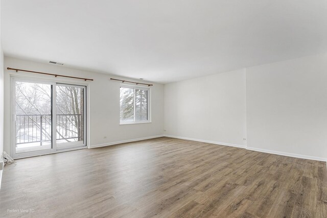 unfurnished room with wood-type flooring