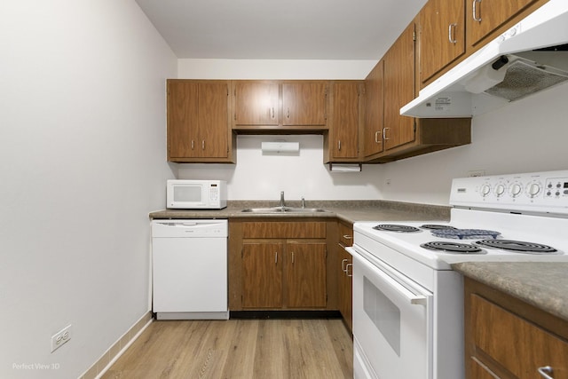 kitchen with sink, white appliances, and light wood-type flooring