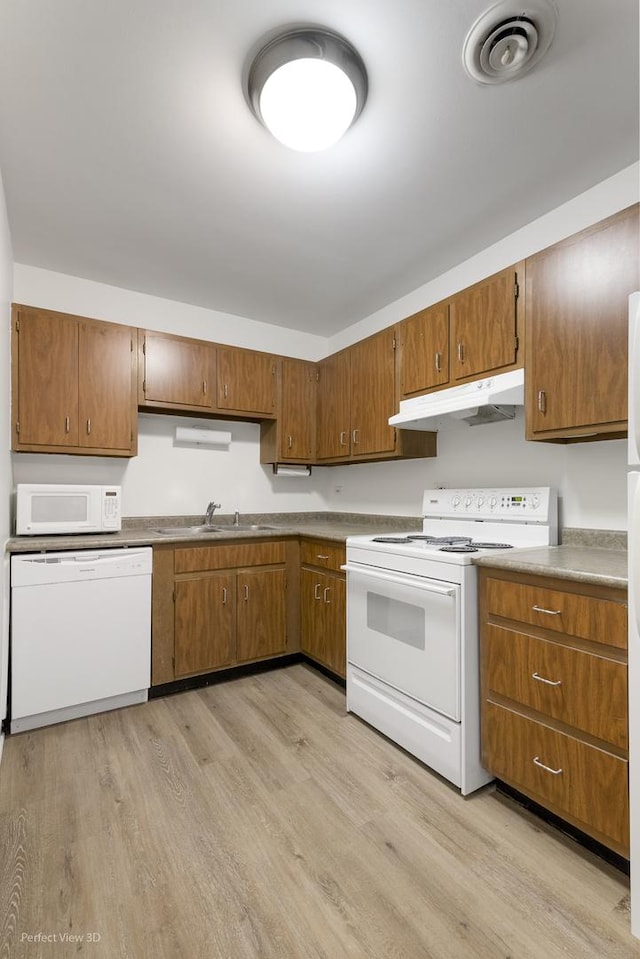 kitchen featuring sink, white appliances, and light wood-type flooring