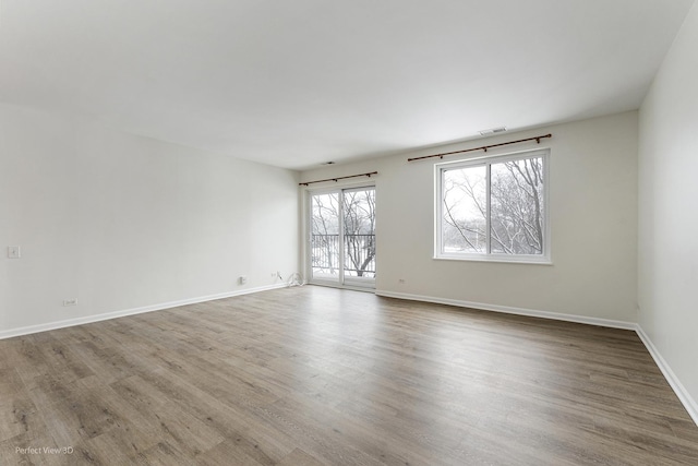 unfurnished room with hardwood / wood-style floors