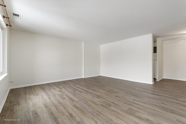 spare room with hardwood / wood-style floors and ceiling fan