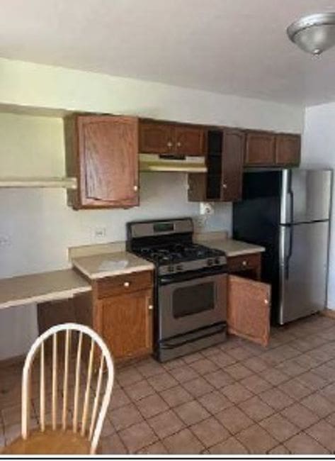 3710 Briar Ln, Hazel Crest, IL 60429 - kitchen featuring light countertops, appliances with stainless steel finishes, light tile patterned floors, and under cabinet range hood