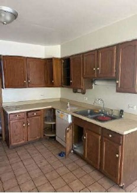 3710 Briar Ln, Hazel Crest, IL 60429 - kitchen featuring a sink, light tile patterned floors, white dishwasher, and light countertops