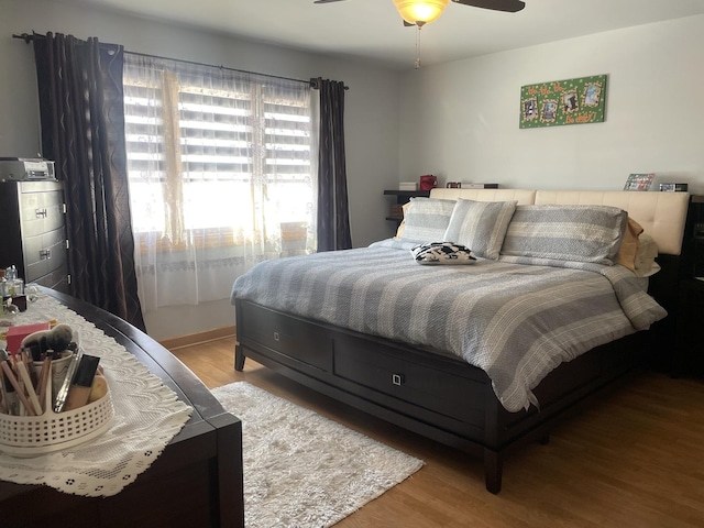 bedroom with ceiling fan and light wood-type flooring