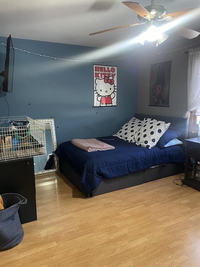 bedroom with ceiling fan and hardwood / wood-style floors