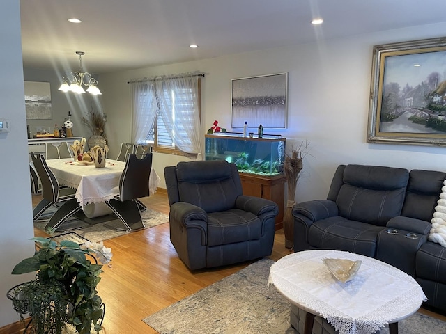 living room with light wood-type flooring and a notable chandelier