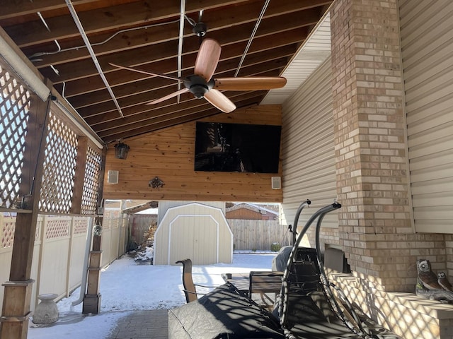 view of patio / terrace with ceiling fan and a shed