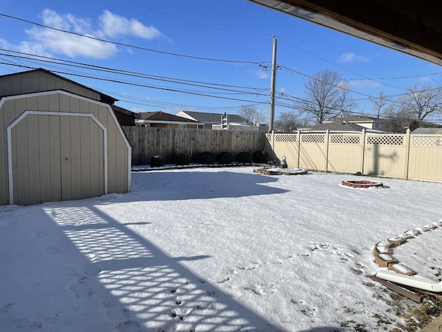 view of yard featuring an outdoor fire pit and a shed