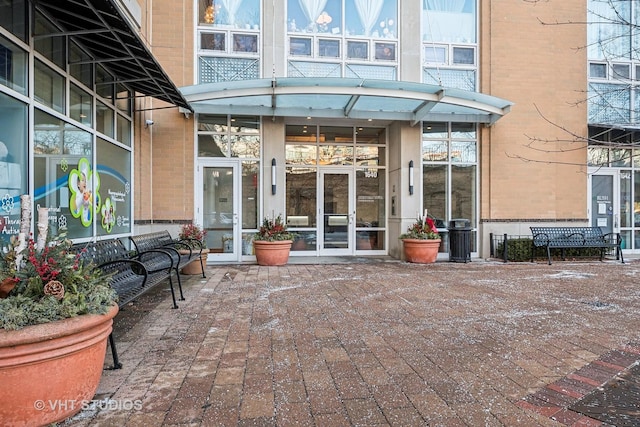 view of exterior entry with brick siding