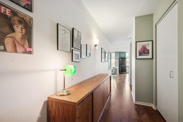 hall featuring dark wood-style floors and baseboards