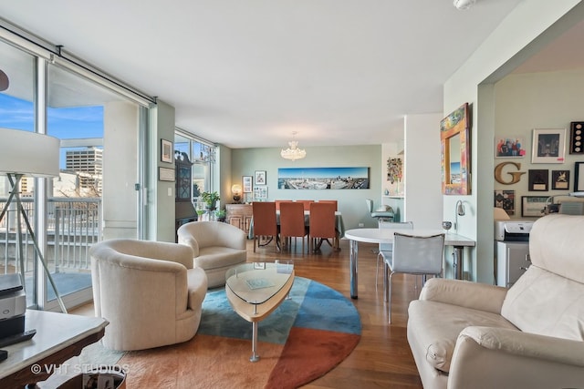 living room featuring floor to ceiling windows, a chandelier, and wood finished floors