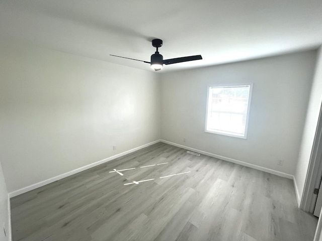 unfurnished room with ceiling fan and light hardwood / wood-style floors