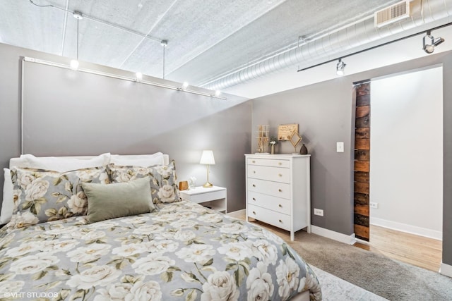 carpeted bedroom with visible vents and baseboards