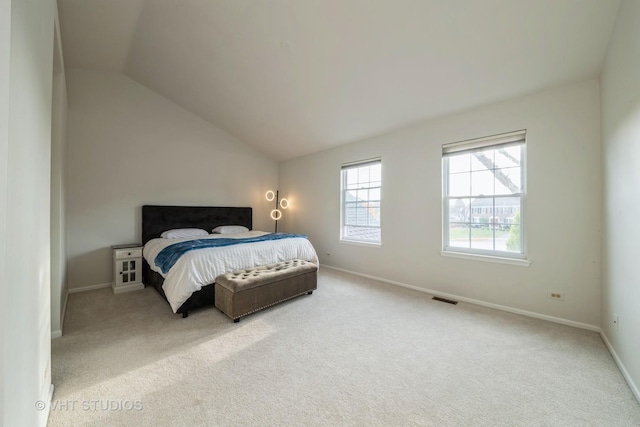 bedroom with light carpet and vaulted ceiling