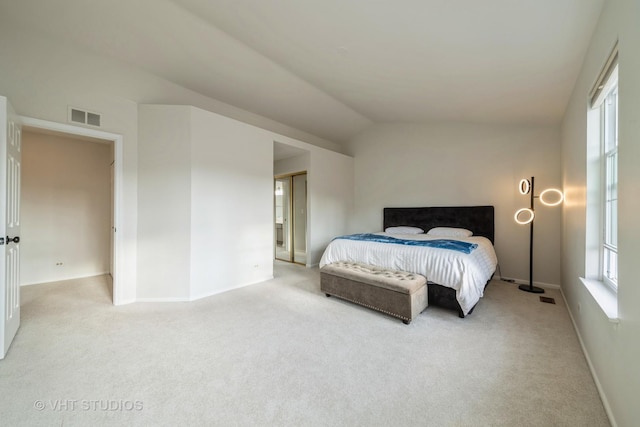 carpeted bedroom featuring lofted ceiling