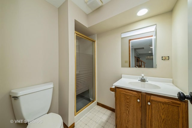 bathroom with vanity, toilet, and a shower with door