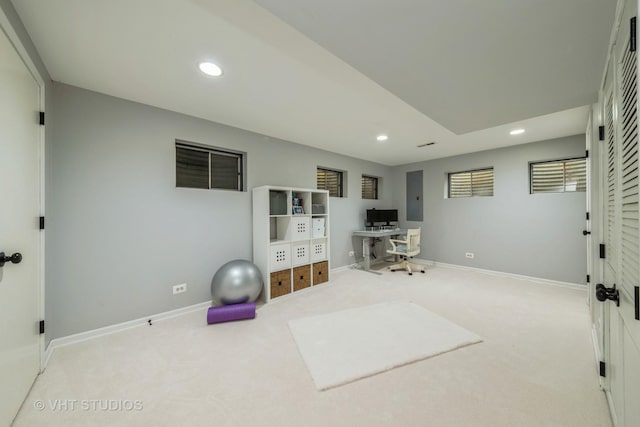 workout room featuring electric panel and light carpet