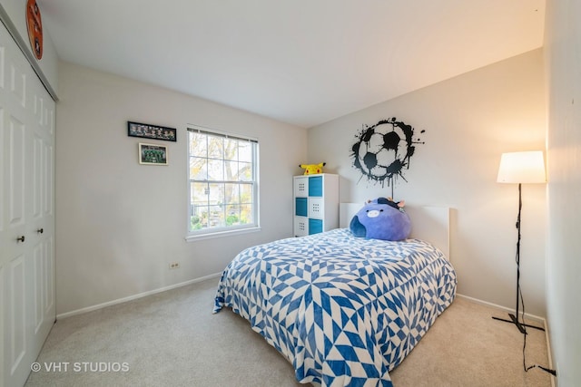 bedroom with light carpet and a closet