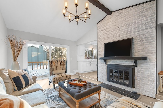 living room featuring a fireplace, high vaulted ceiling, an inviting chandelier, and beamed ceiling