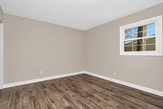 empty room with dark hardwood / wood-style flooring