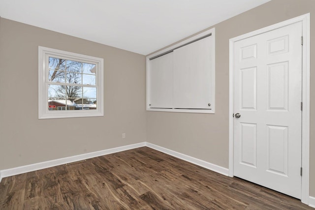 empty room with dark wood-type flooring