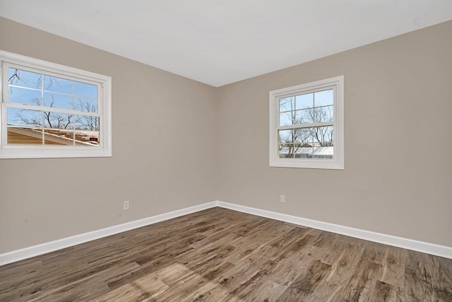 empty room with hardwood / wood-style flooring