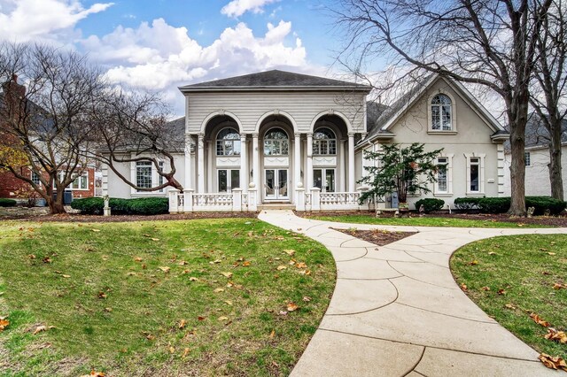 view of front of property featuring french doors and a front lawn