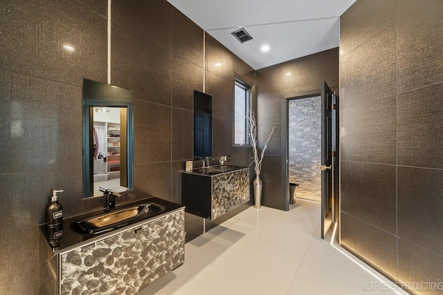 bathroom featuring tile walls, tile patterned flooring, and vanity