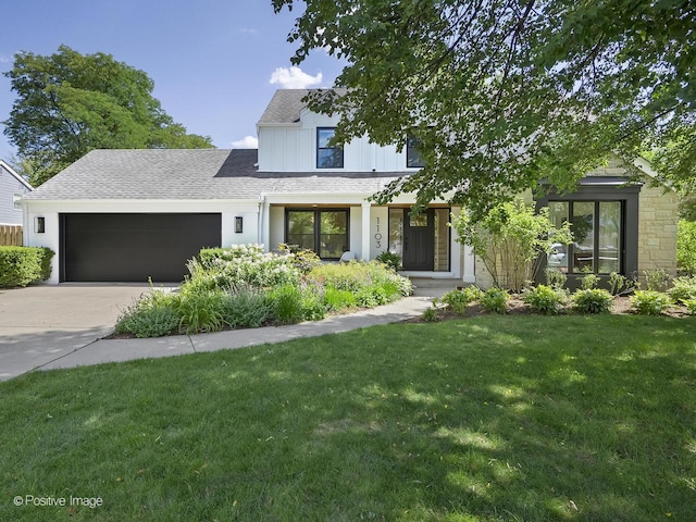 modern farmhouse style home featuring a garage and a front lawn