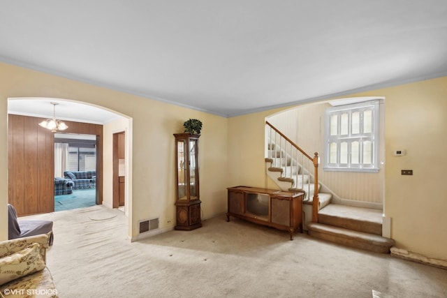 interior space with a notable chandelier and ornamental molding