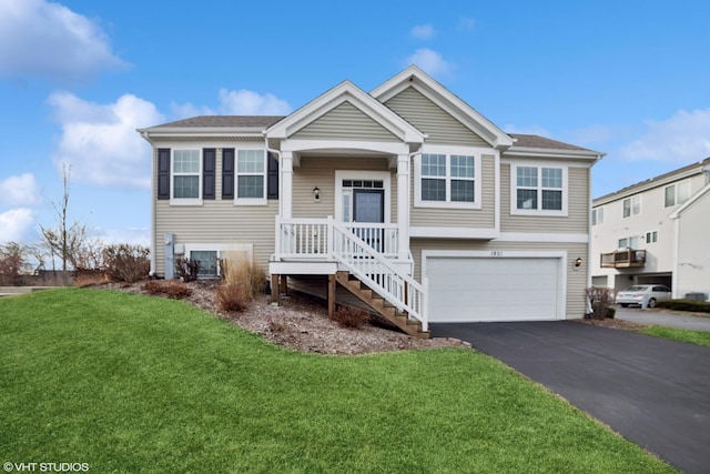 bi-level home featuring cooling unit, a front yard, and a garage