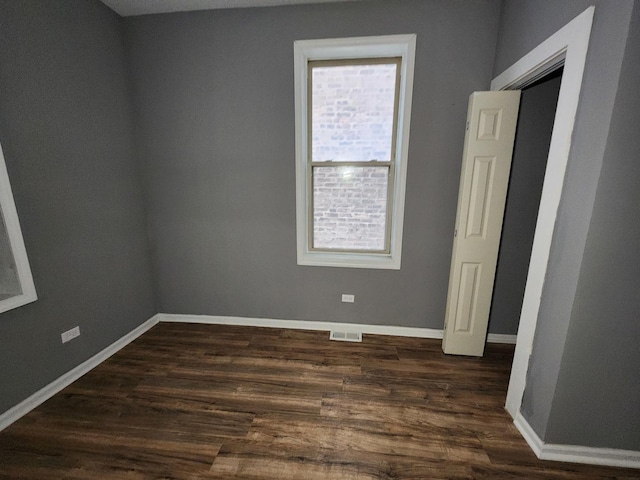 spare room with dark hardwood / wood-style flooring