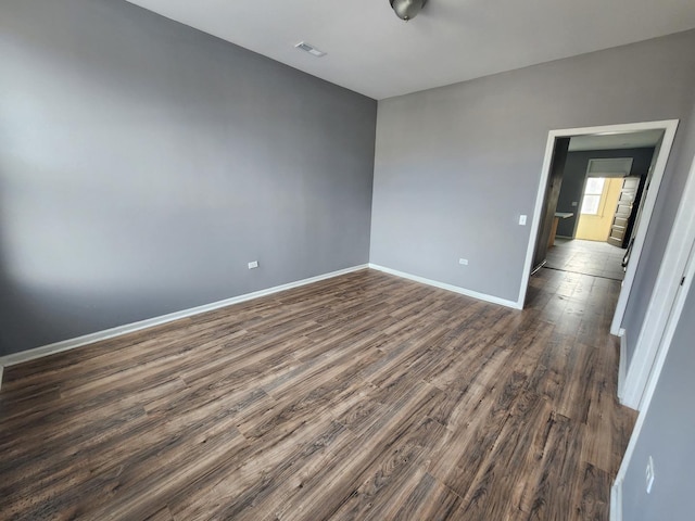 spare room featuring dark wood-type flooring