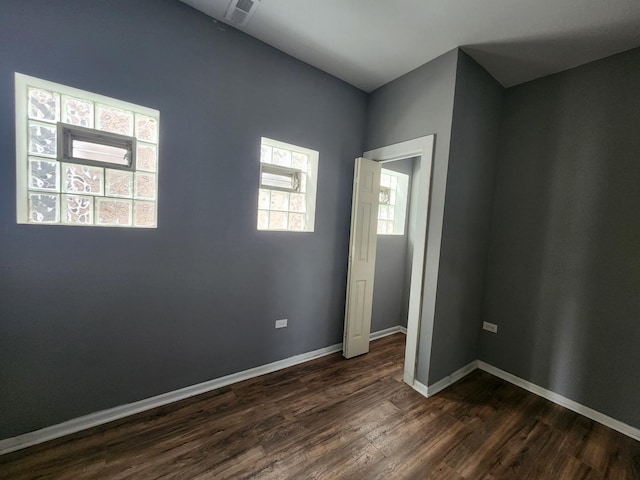 spare room featuring dark wood-type flooring